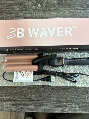 The Beachwaver Co. curling iron box in brown and pink accents